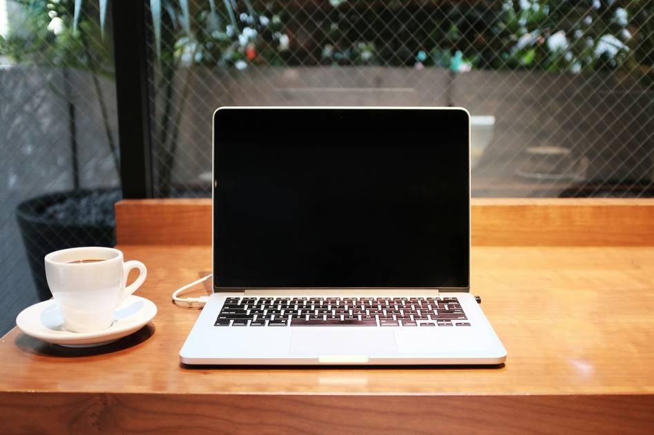Modern workspace with AI productivity dashboard on laptop screen